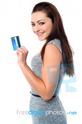 fashionable young girl holding up a credit card stock photo
