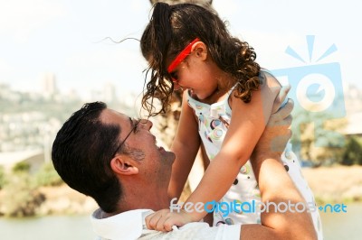 Father Lifting His Daughter Stock Photo