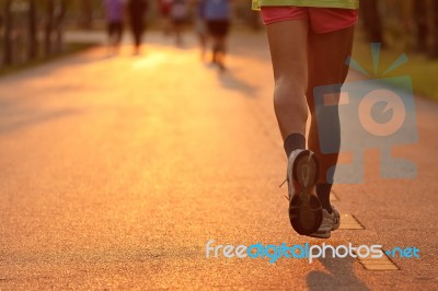 Feet Of Runner In Evening Light Stock Photo