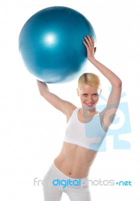 Female Athlete raising Blue Ball Stock Photo