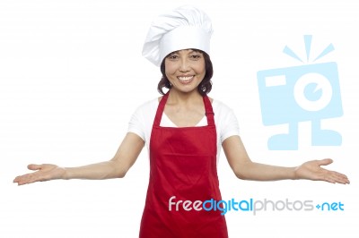 Female Chef Showing Welcome Gesture Stock Photo