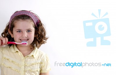 Female Child Brushing Her Teeth Stock Photo