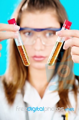 Female Doctor Holding Two Chemical Tubes Stock Photo