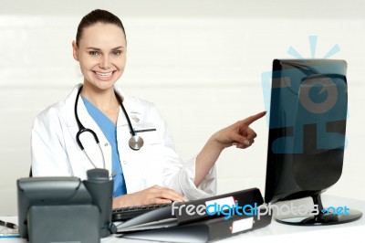 Female Doctor Pointing Screen Stock Photo