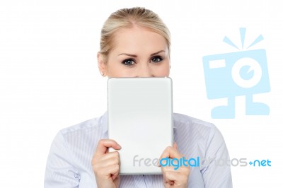 Female Model Hiding Face With Tablet Pc Stock Photo
