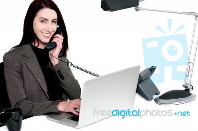 Female Operator Talking On Phone And Smiling Stock Photo