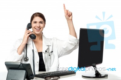 Female Physician Answering Phone Call Stock Photo