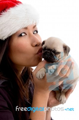Female With Hat And Kissing Puppy Stock Photo