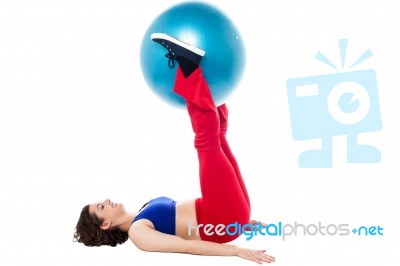 Fit Woman Holding Exercise Ball Between Legs Stock Photo