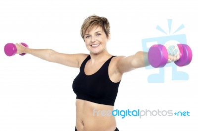 Fitness Woman Working Out With Pink Dumbbells Stock Photo