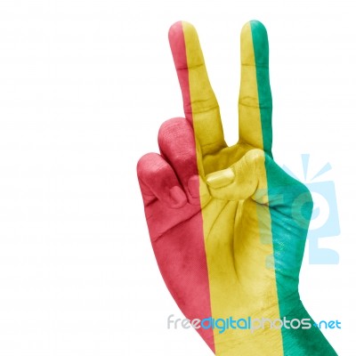Flag Of Guinea In Victory Hand Stock Photo