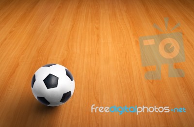Football On Wooden Floor Stock Photo