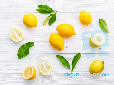 Fresh Lemons And  Lemons Leaves On White Wooden Background Stock Photo