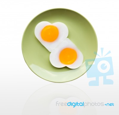 Fried Egg Heart On Green Dish Stock Photo