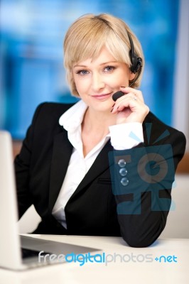 Friendly Female Operator With Headset Stock Photo