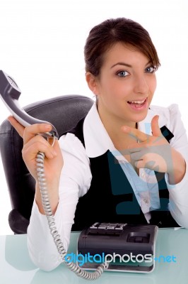 Front View Of Happy Businesswoman Pointing At Phone Stock Photo