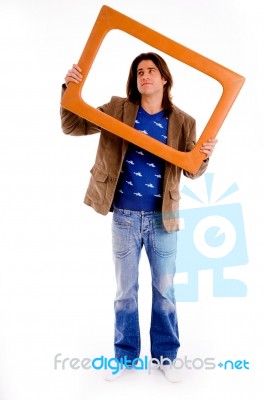 Front View Of Male Holding Frame And Looking Up Stock Photo