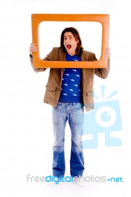 Front View Of Man Looking Through Frame Stock Photo