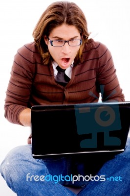 Front View Of Shocked Man Looking At Laptop Stock Photo
