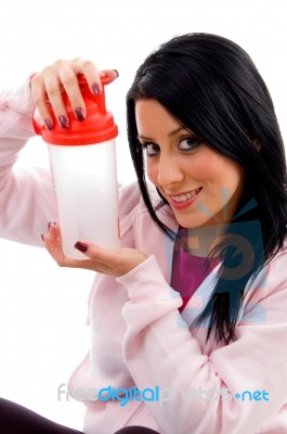 Front View Of Smiling Female Holding Water Bottle On White Background Stock Photo