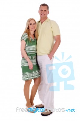 Full Length Of Smiling Middle Aged Couple Standing And Looking At You Stock Photo