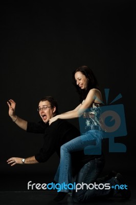 Funny Young Couple Play In Studio Stock Photo