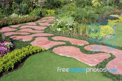 Garden With Red Paved Path Stock Photo