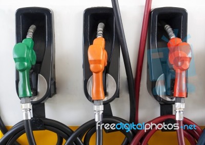 Gas Pump Nozzles At Gas Station Stock Photo