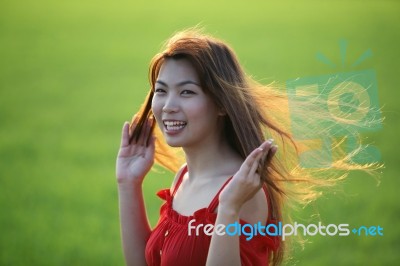 Girl Blowing Beautiful Hair With Green Background Stock Photo