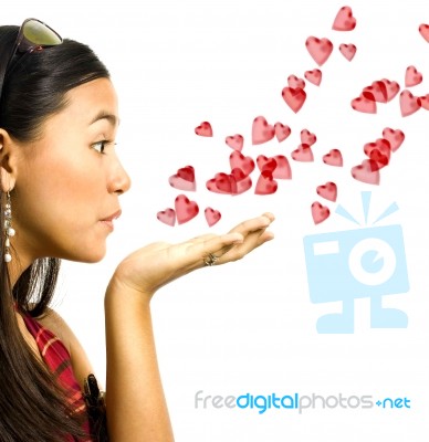 Girl Blowing Hearts Stock Photo