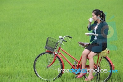 Girl Drinking Tea In Field Stock Photo