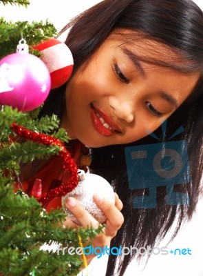 Girl Holding Christmas Bauble Stock Photo