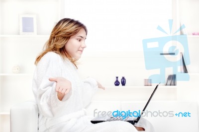 Girl In Bathrobe Chatting On Computer Stock Photo