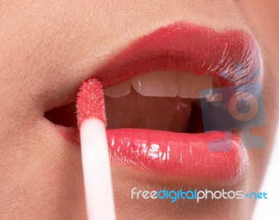 Girl Putting On Lip Gloss Stock Photo