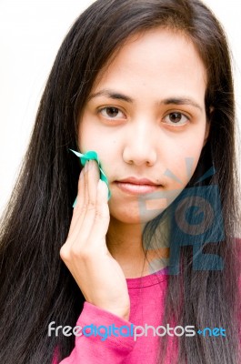 Girl Wiping Oily Skin Stock Photo