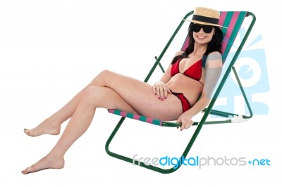 Glamorous Bikini Model Relaxing On Reclining Chair Stock Photo