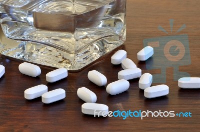 Glass And Pills Stock Photo