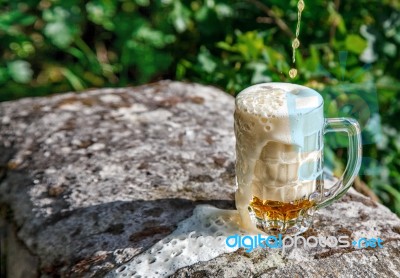 Glass Mug With Beer Standing On The Big Stone Stock Photo