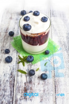 Glass Of Yogurt With Fresh Blueberries Stock Photo