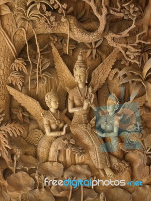 Goddess, Wood Carving In A Thai Temple Stock Photo
