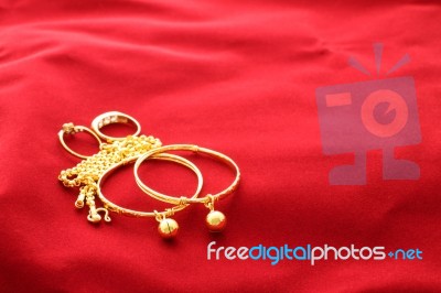 Gold Jewelry Ornament On Wide Red Floor Stock Photo