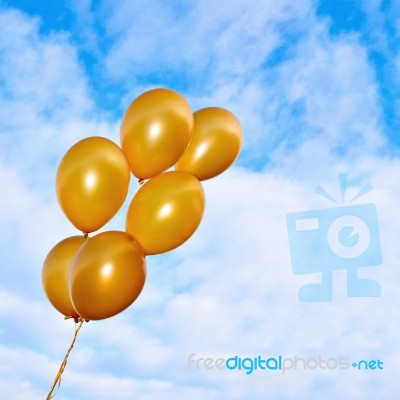 Golden Flying Balloons On The Sky Background Stock Photo
