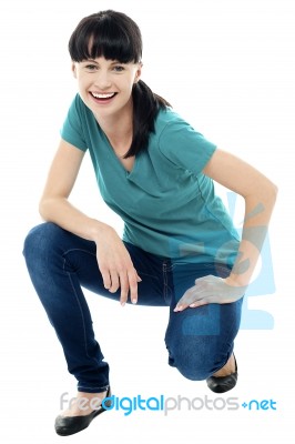 Good Looking Female Model In Squatting Posture Stock Photo