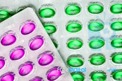 Green And Pink Oil Pills Stock Photo