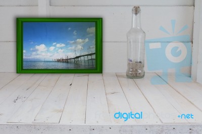 Green Picture Frame And Bottle Seashell In White Room Stock Photo