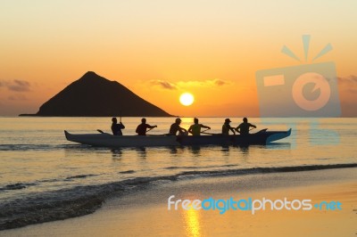 Group Of People In Boat At Sunset Stock Photo
