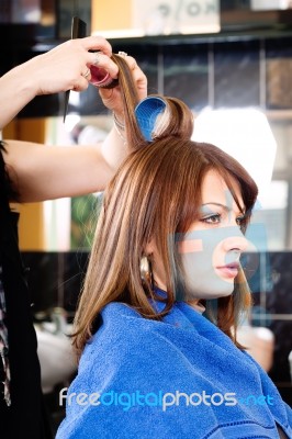 Hairdresser Putting Rollers On Hair Stock Photo