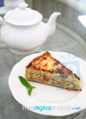 Ham And Bacon Quiche With Teapot Stock Photo