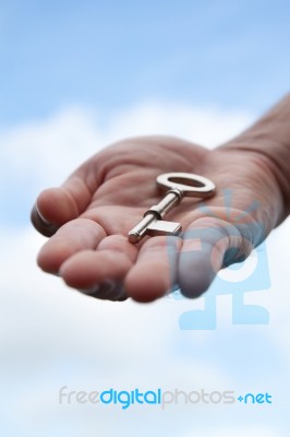 Hand Giving A Key   Stock Photo