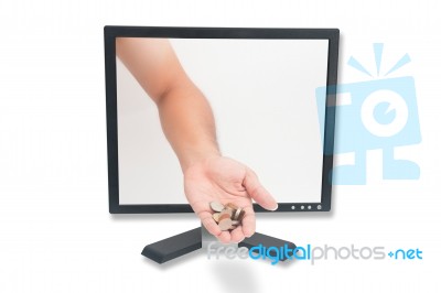 Hand Giving Coin Through Computer Stock Photo
